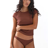 Woman wearing a brown t-shirt and underwear set on a white background