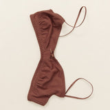 Brown bra with thin straps on a beige background