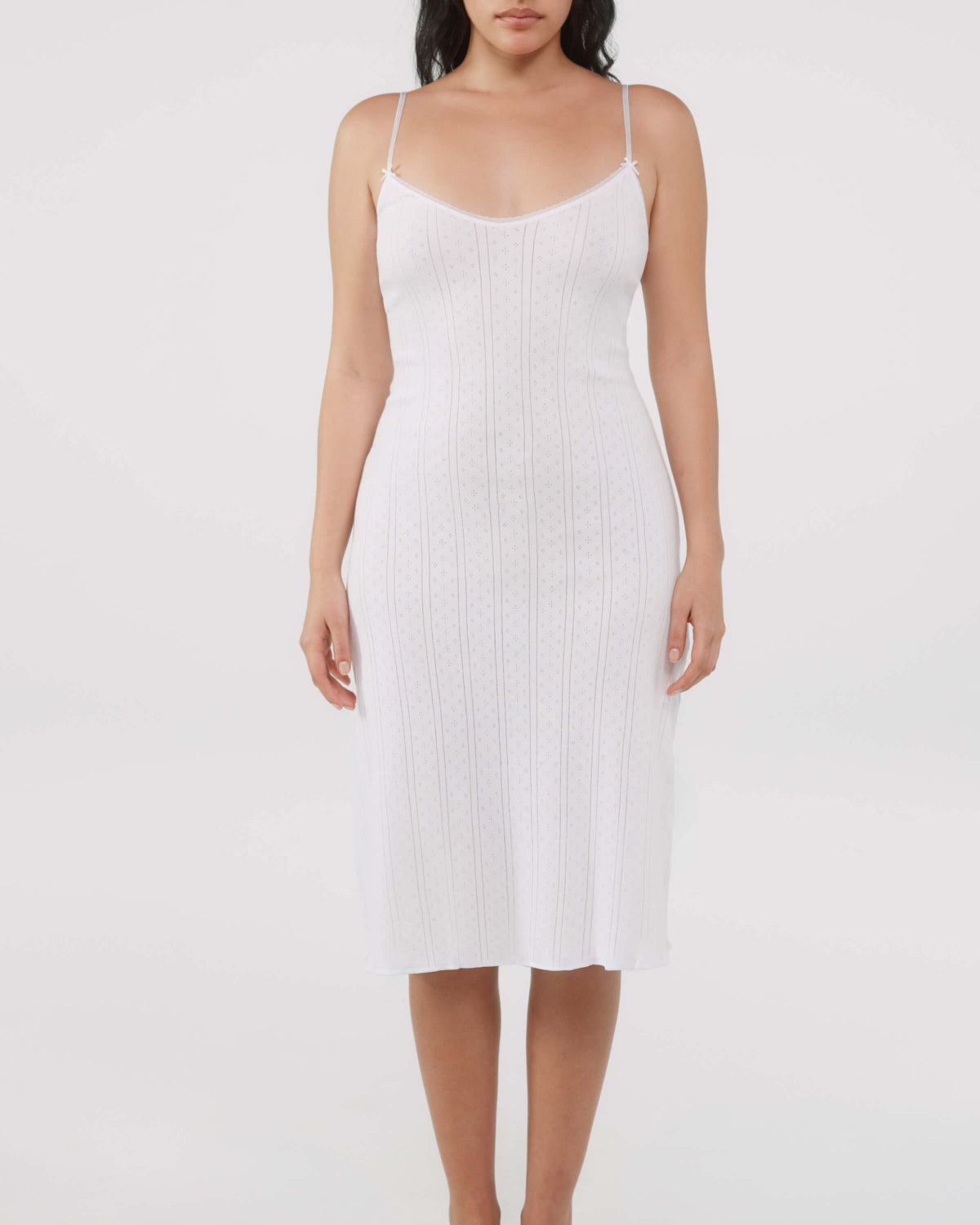 White slip dress worn by a model on a white background
