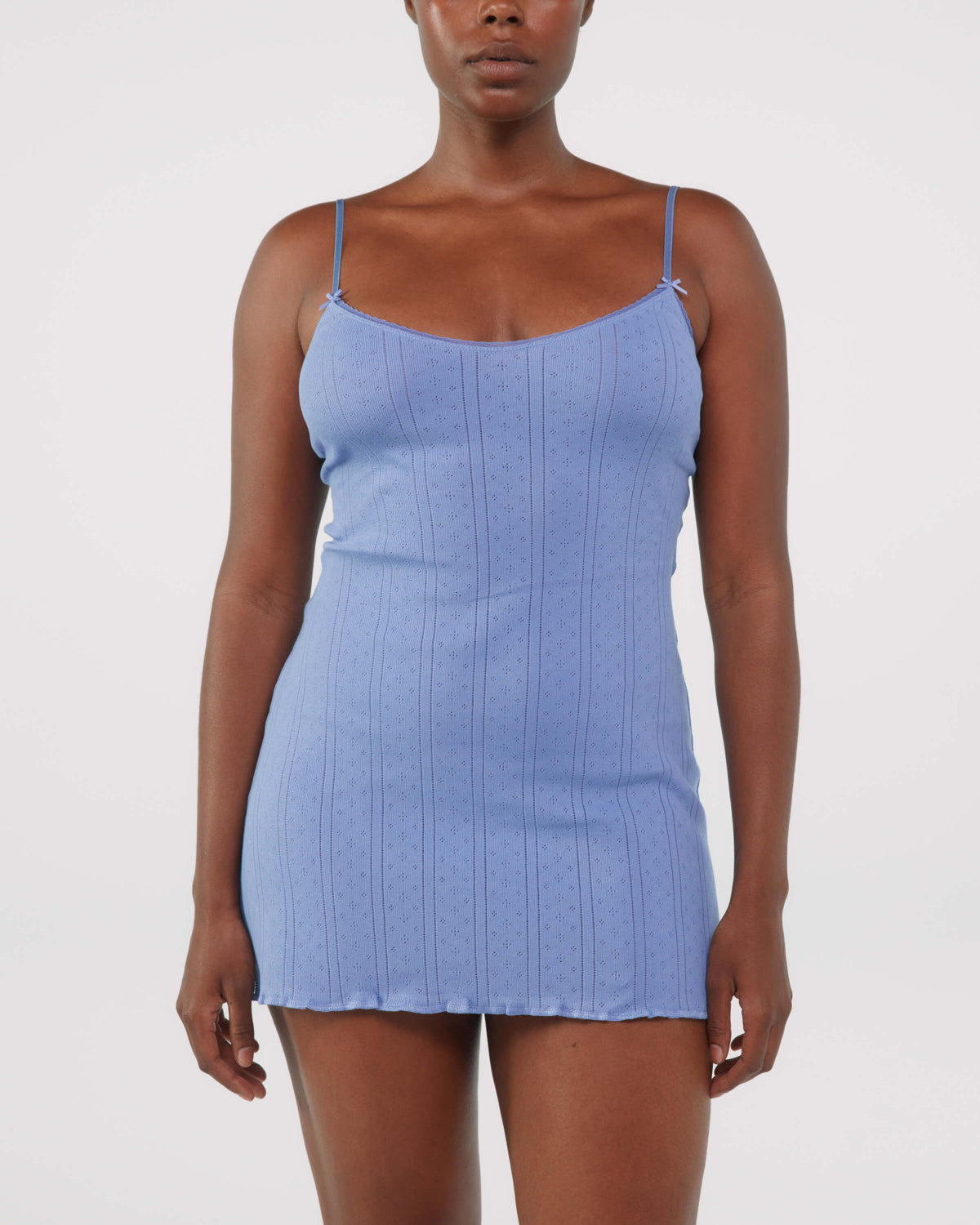 Woman wearing a blue dress against a white background