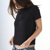 Person wearing a black t-shirt and blue jeans on a white background