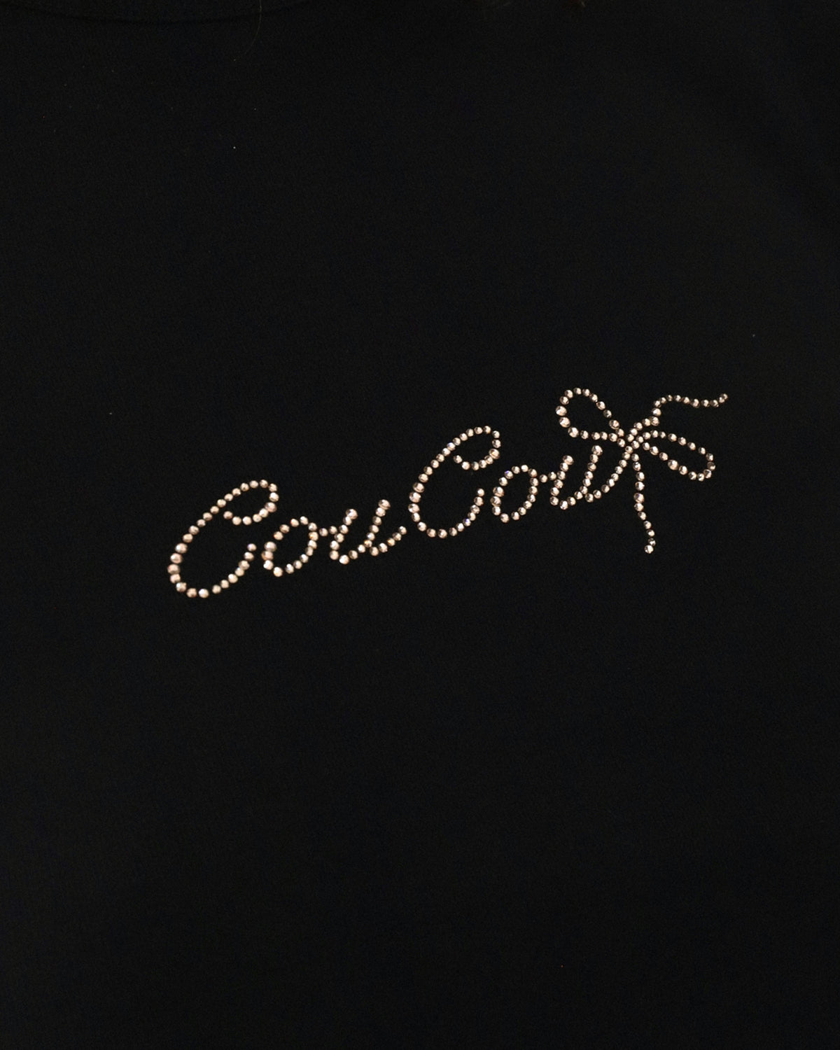Black background with Cou Cou text in rhinestones
