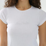 White t-shirt with a brand logo worn by a person on a white background