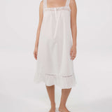 Woman wearing a white nightgown with lace details on a white background