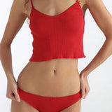 Red underwear set worn by a model on a white background