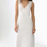 White dress with lace details on a white background