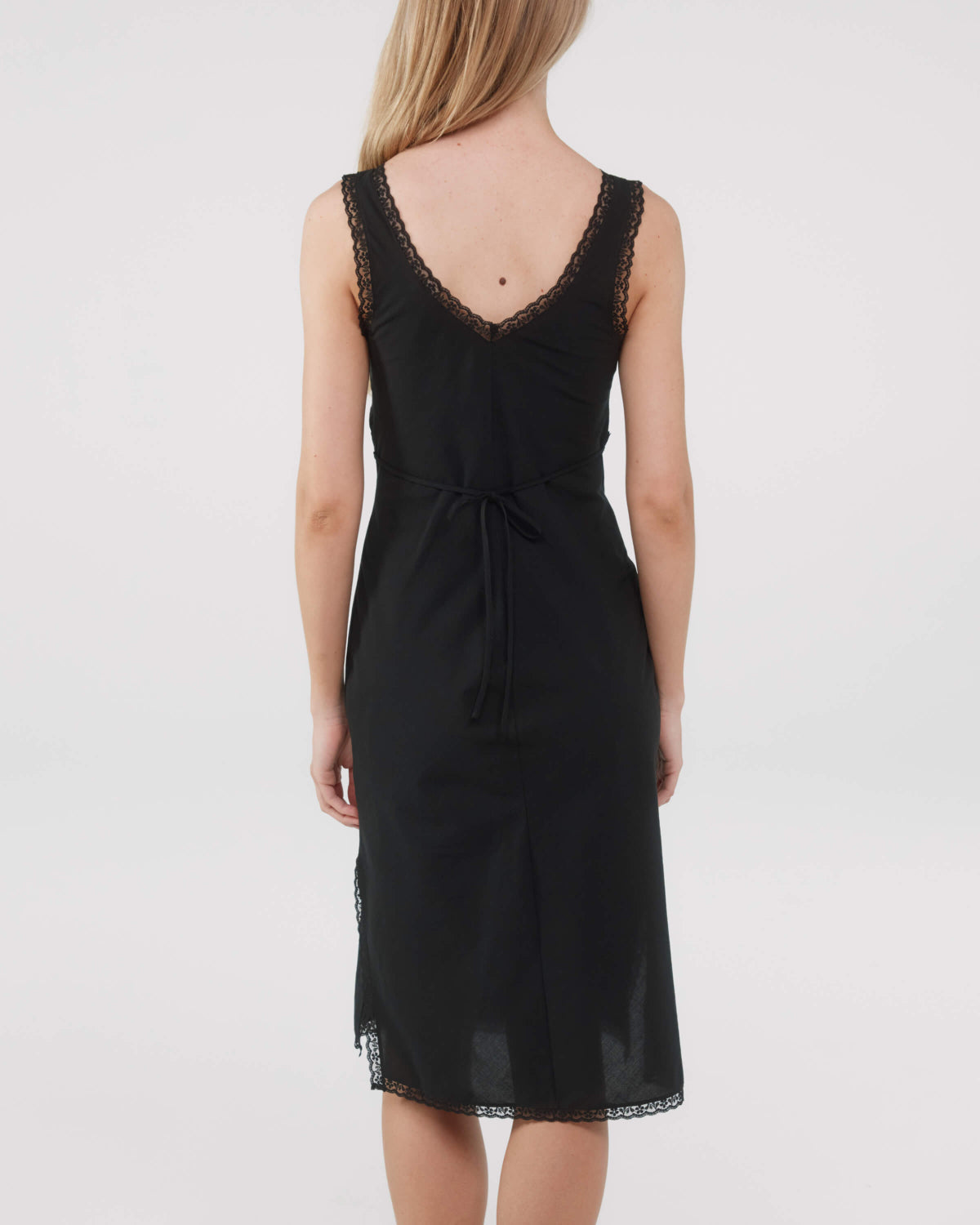 Black dress with lace details on a white background