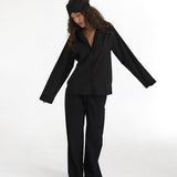 Person wearing a black outfit on a white background