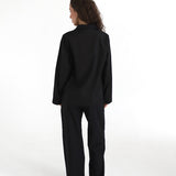 Person wearing a black outfit on a white background