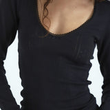 Black long-sleeve top with lace trim neckline on a white background
