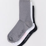 Three socks in gray, white, and black on a light gray background.
