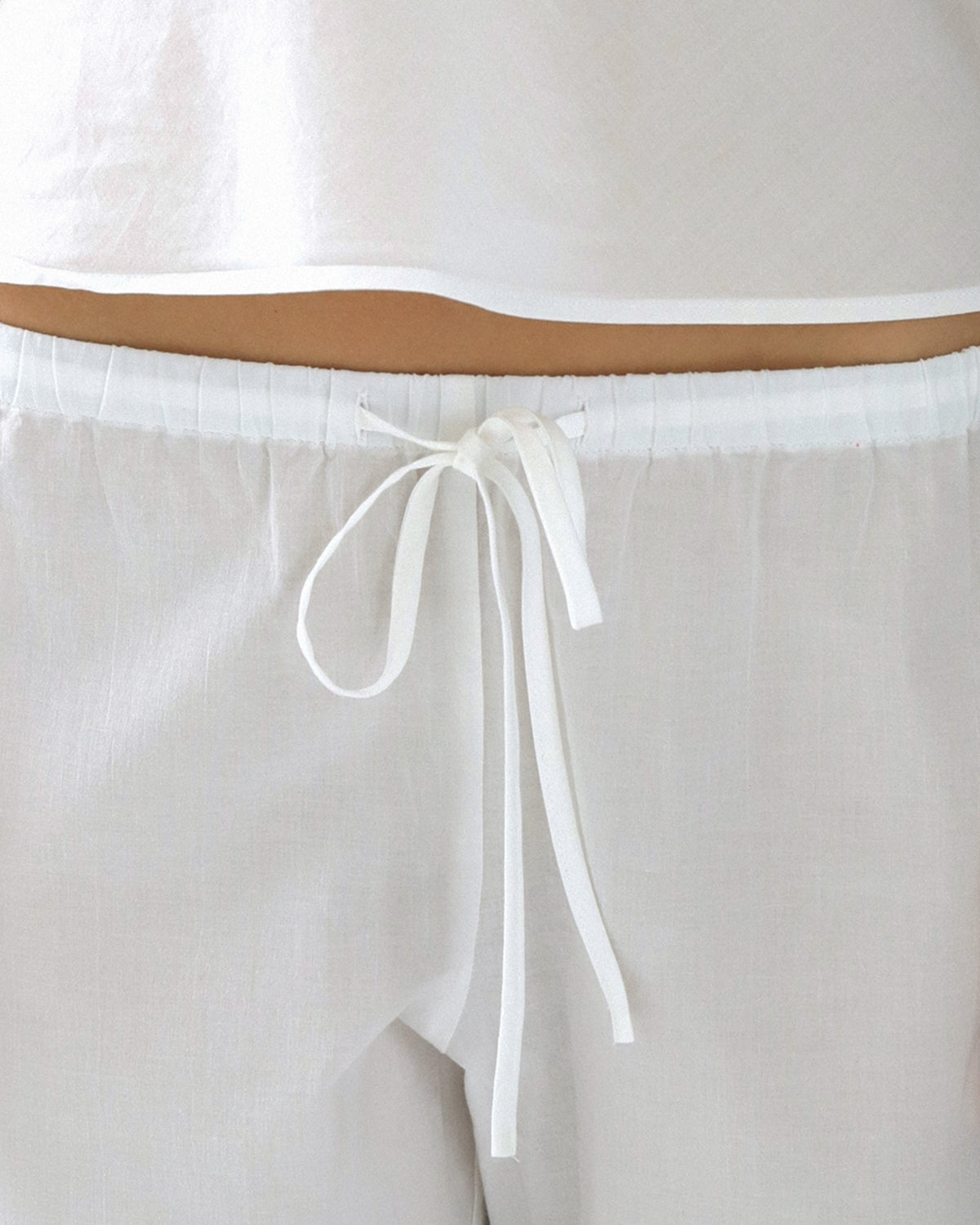 White pants with a drawstring on a light gray background
