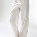 White wide-leg pants worn by a person on a white background