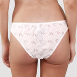 Floral-patterned underwear worn by a person on a plain background