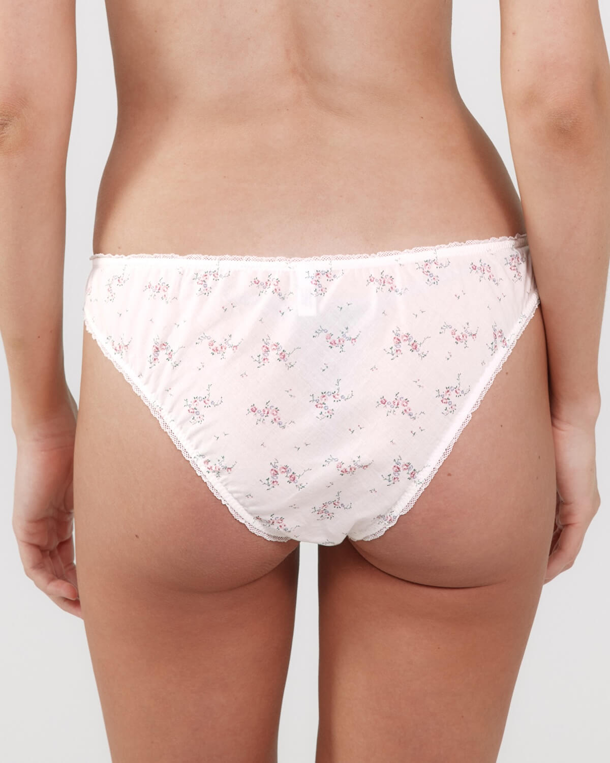 Floral-patterned underwear worn by a person on a plain background