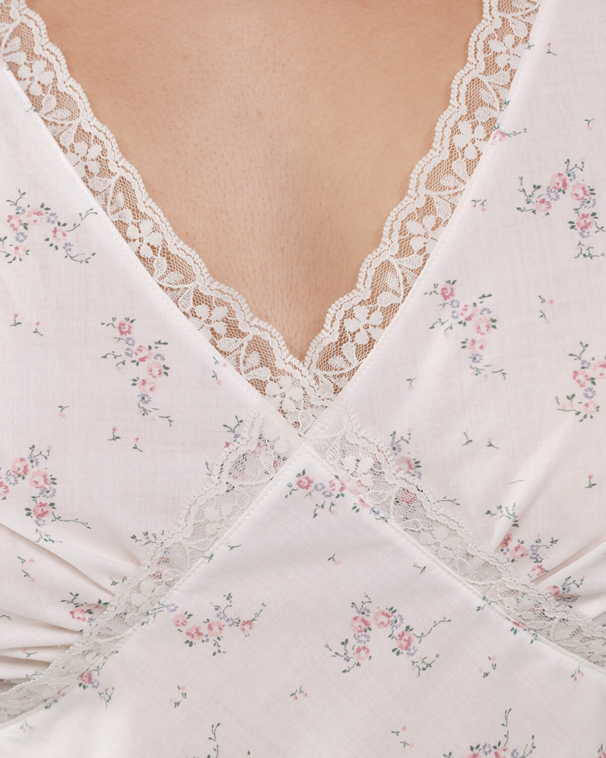 Close-up of a white lace garment with floral patterns